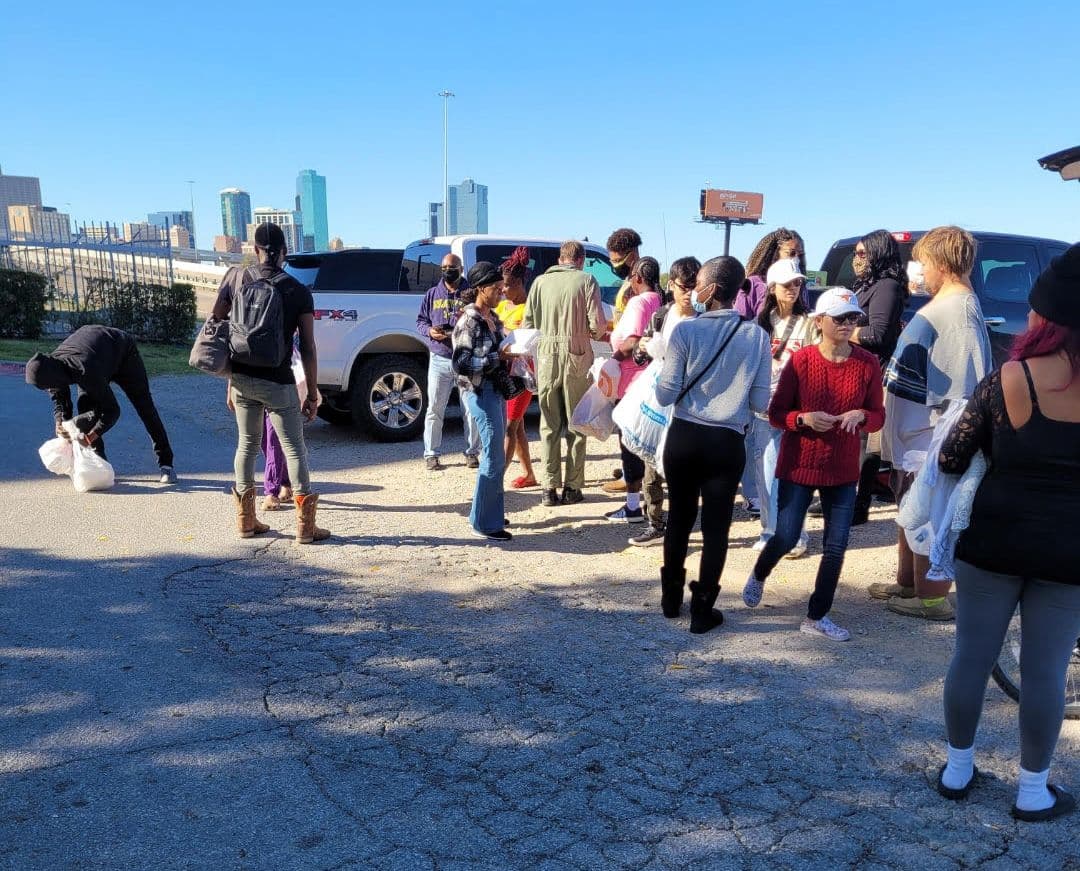 Neighbors and volunteers gathered in a parking lot during an FTCC outreach