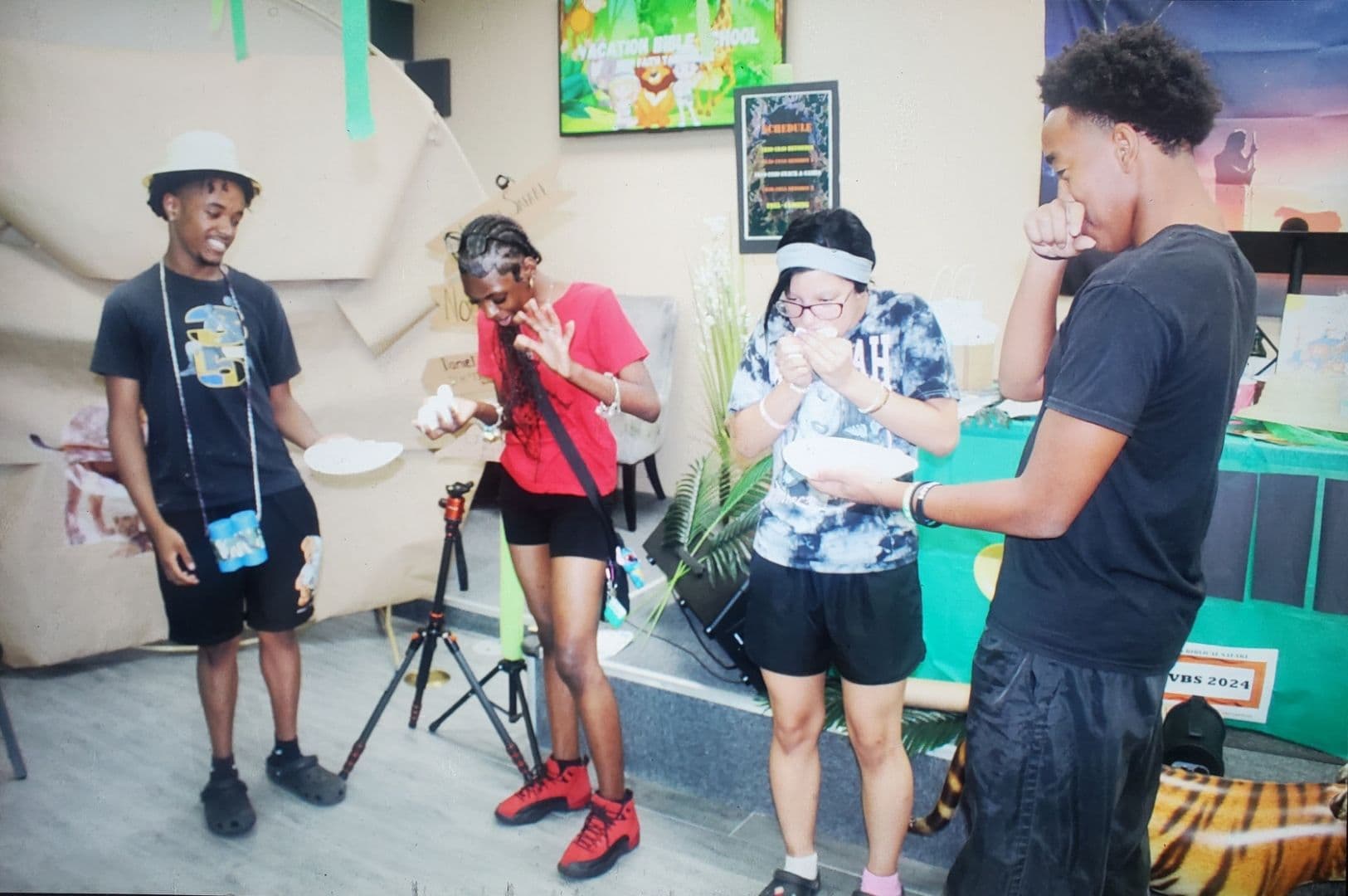 Teens laughing together during a game at Vacation Bible School