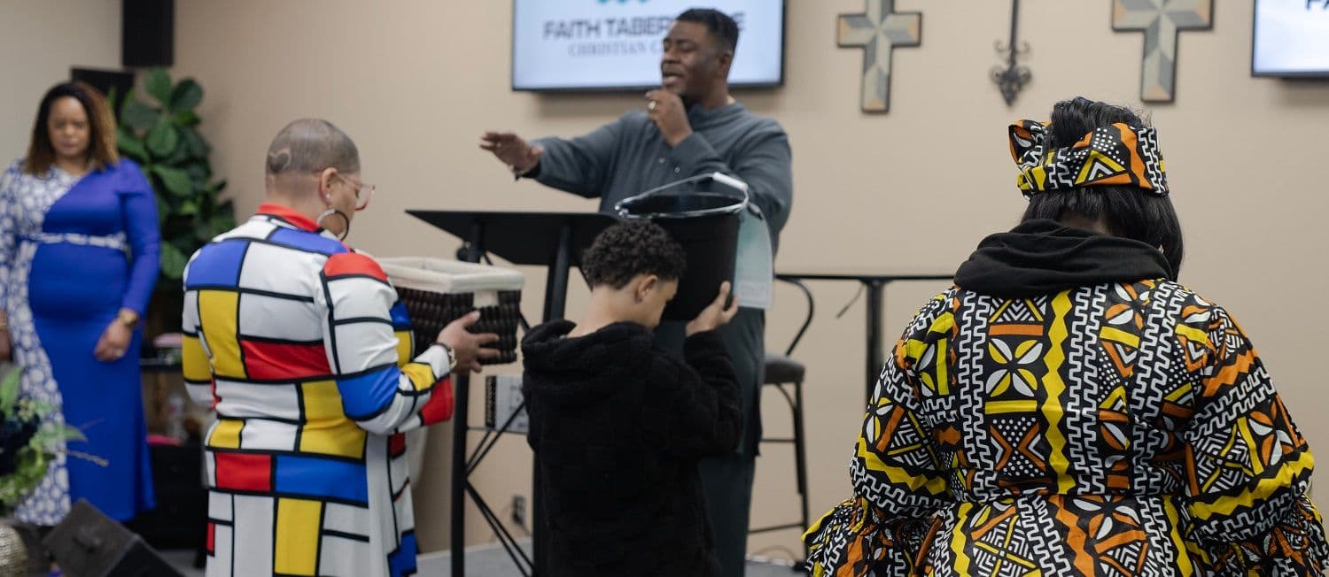 Members bringing their offering forward during a service