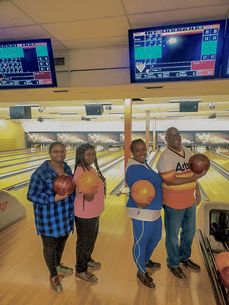 Faith Squad Youth members holding bowling balls on a group outing